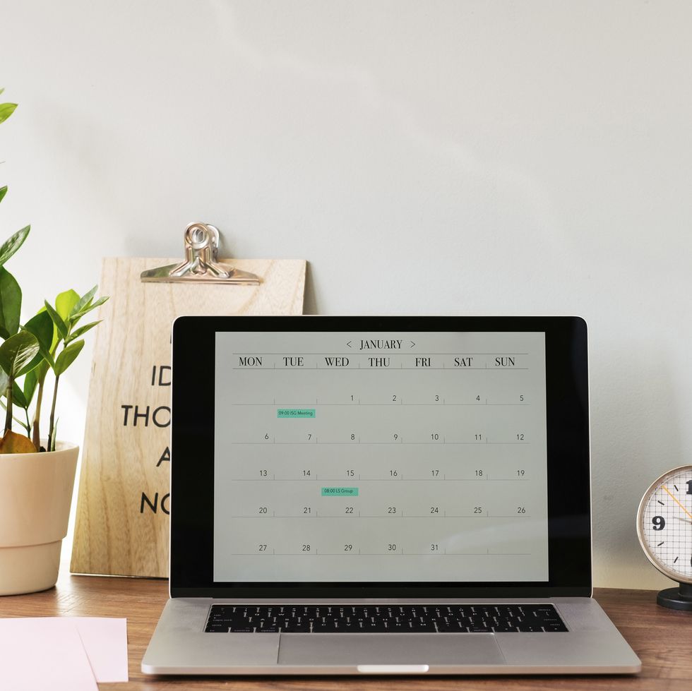 opened laptop with a calendar on desk at home royalty free image 1584043986
