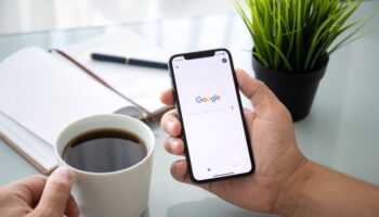 man holding iphone searching goo