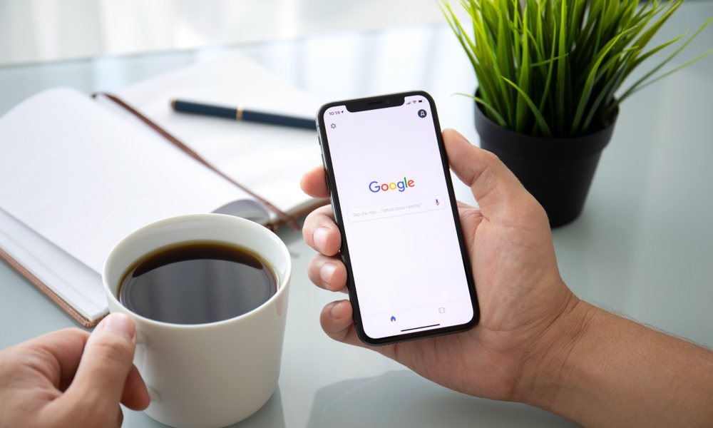 man holding iphone searching goo