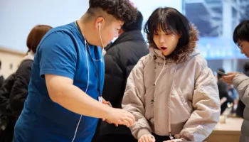 Apple Hongdae Seoul opening day team member helping customer