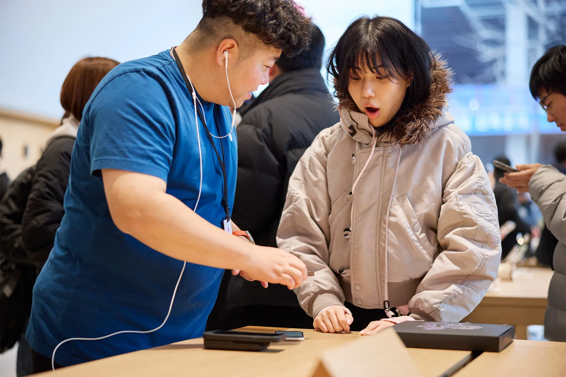 Apple Hongdae Seoul opening day team member helping customer jpg
