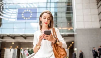 Woman with smartphone EU flag sm