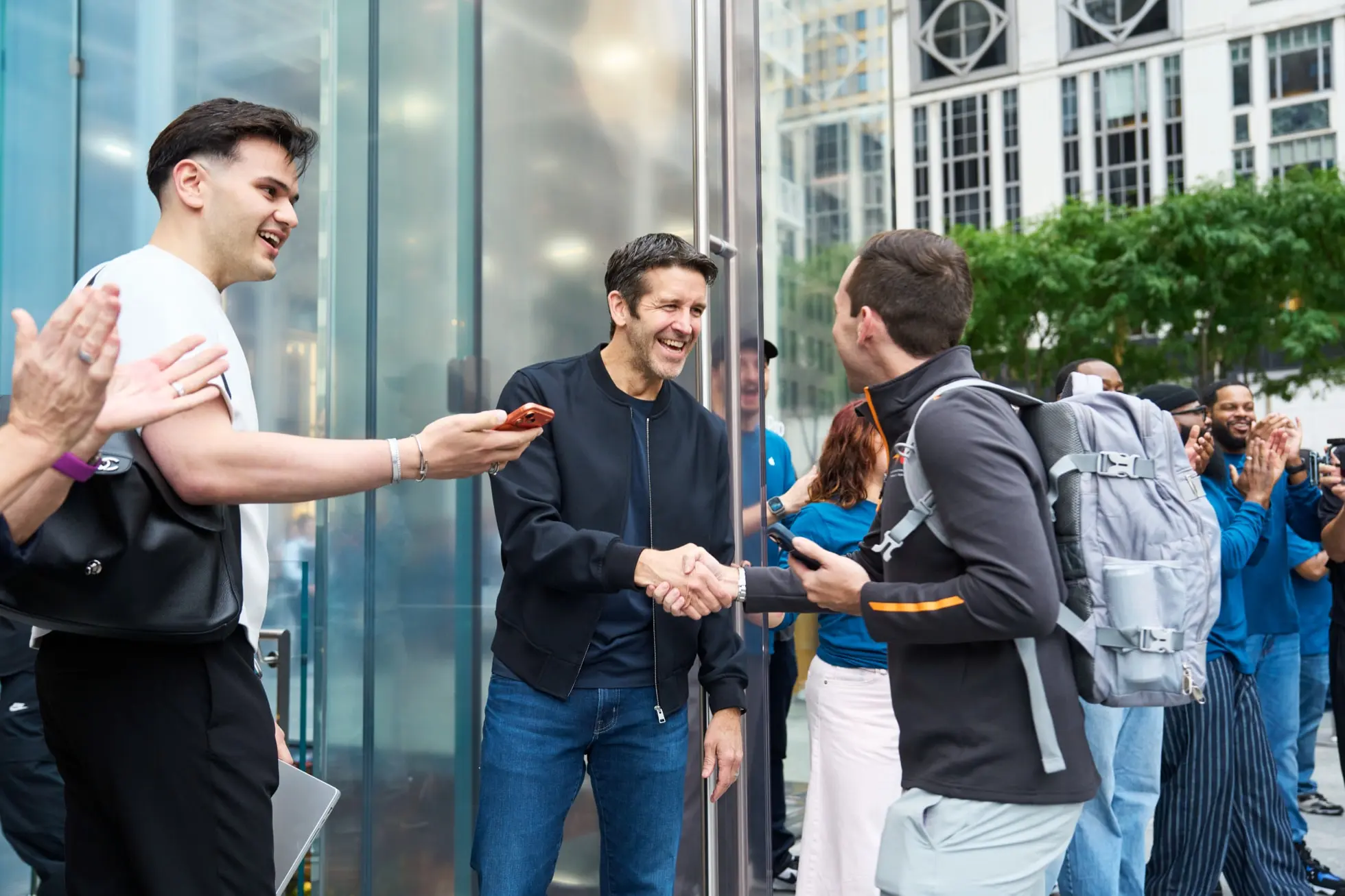 Apple Fifth Avenue New York John Ternus shaking hands with customer